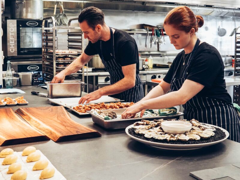 Deux cuisiniers qui préparent le repas pour un buffet dans la cuisine d'un restaurant